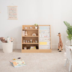 Wooden kids bookshelf with open shelving and fabric compartments for books and toys in a playroom