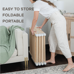 Infographic showing how natural wood baby playpen folds flat for easy storage and travel