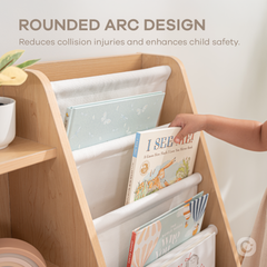 Close-up of natural wood kids bookshelf showing fabric storage bins and wooden shelf structure