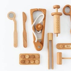 Collection of wooden toys and tools on a white background