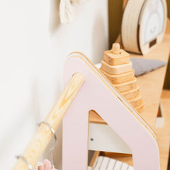 Wooden toy with a pink base on a white background