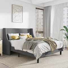 Gray upholstered bed in a modern bedroom with abstract art and curtains.