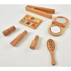 Set of wooden makeup tools including a compact mirror, brush, and color palette on a white background