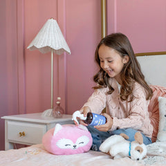 Young girl playing with plush toys on a bed in a bedroom setting