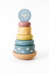 Stack of colorful wooden rings with bird and cloud patterns on a white background