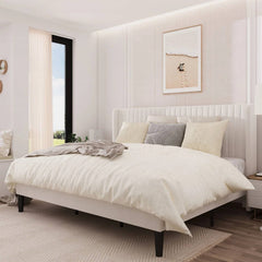 Neatly made bed in a modern bedroom with light decor