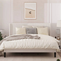 Neatly made bed with white bedding and decorative pillows in a bedroom setting.