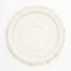 Round woven mat with a textured border on a white background