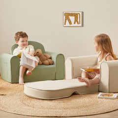 Two children sitting in armchairs with a small table between them, reading books.