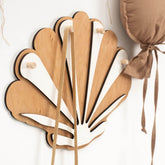 Wooden fan-shaped hook with ribbons on a white background