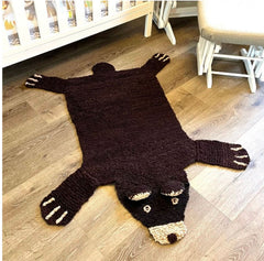 organic wool brown bear play mat in a calm neutral nursery setting