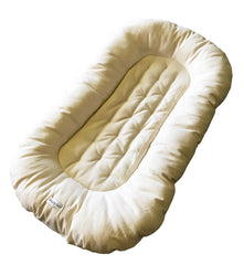 Cream-colored baby nest on a white background