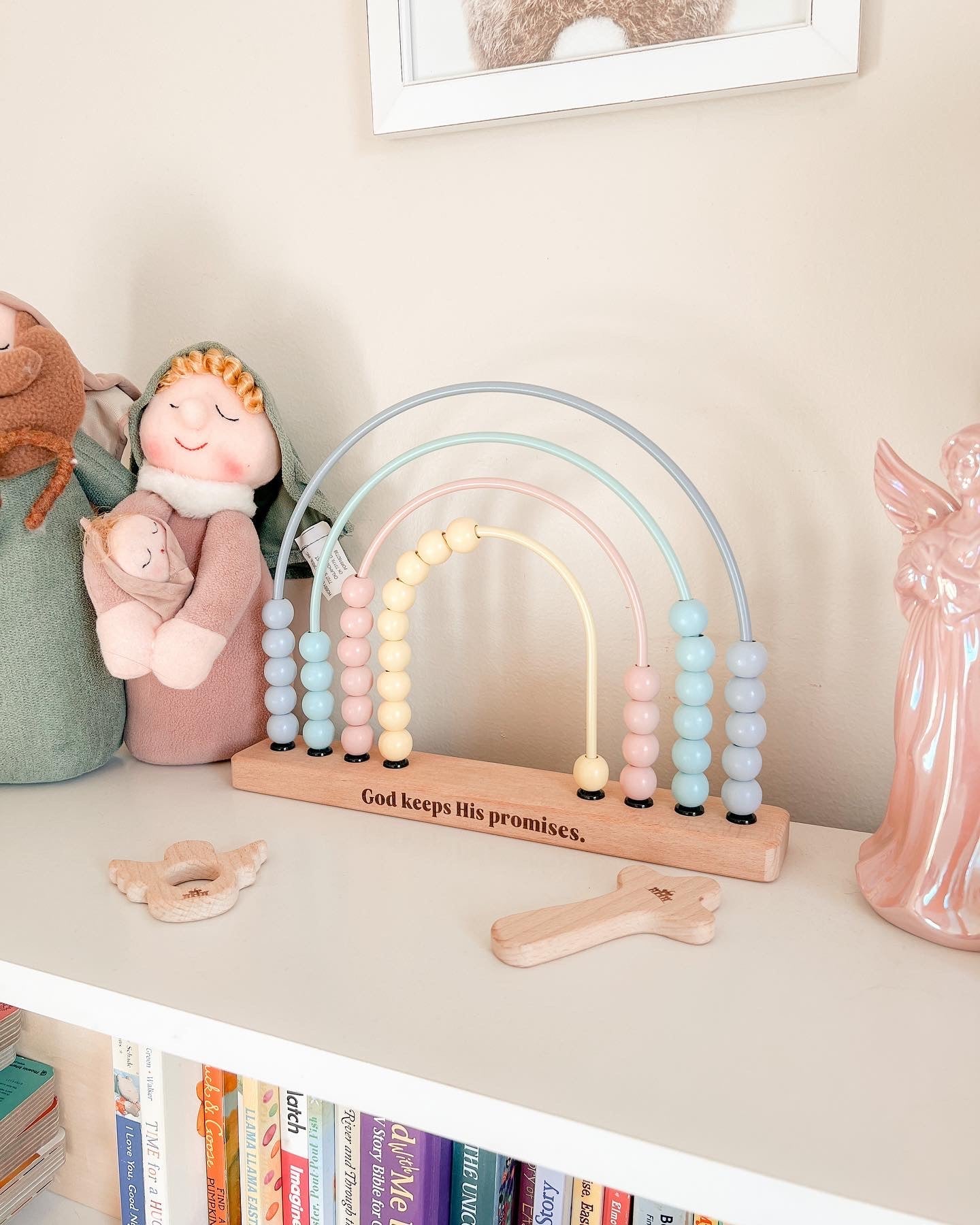 Pastel-colored rainbow abacus on a shelf with decorative items