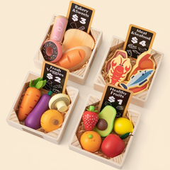 Set of toy food items in wooden boxes with price tags on a beige background