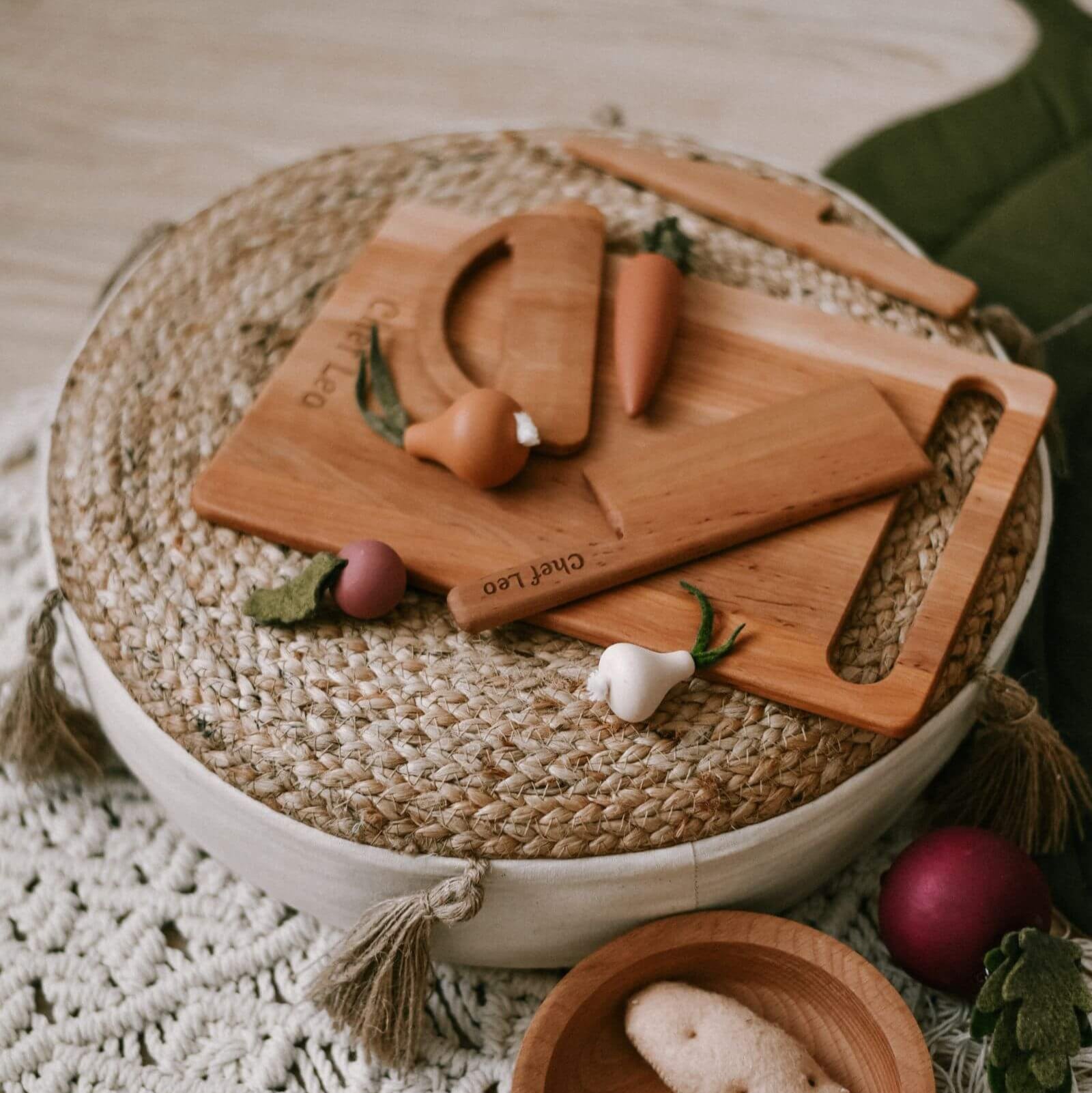 Set of wooden cutting boards with engraved names on a woven mat
