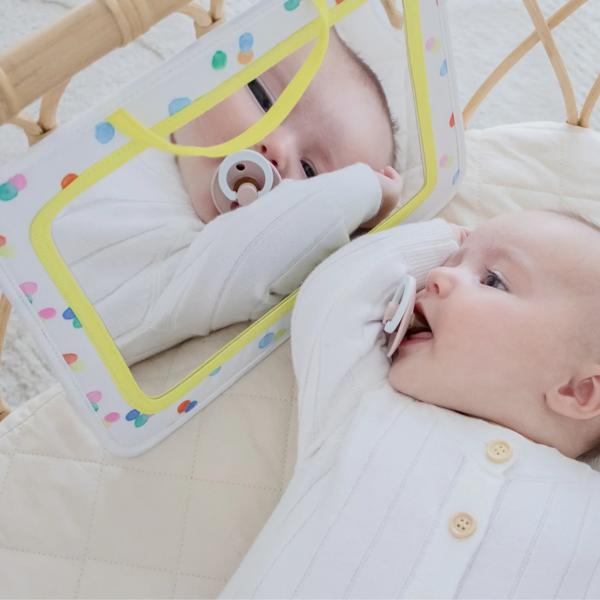 Close up of baby looking in mirror