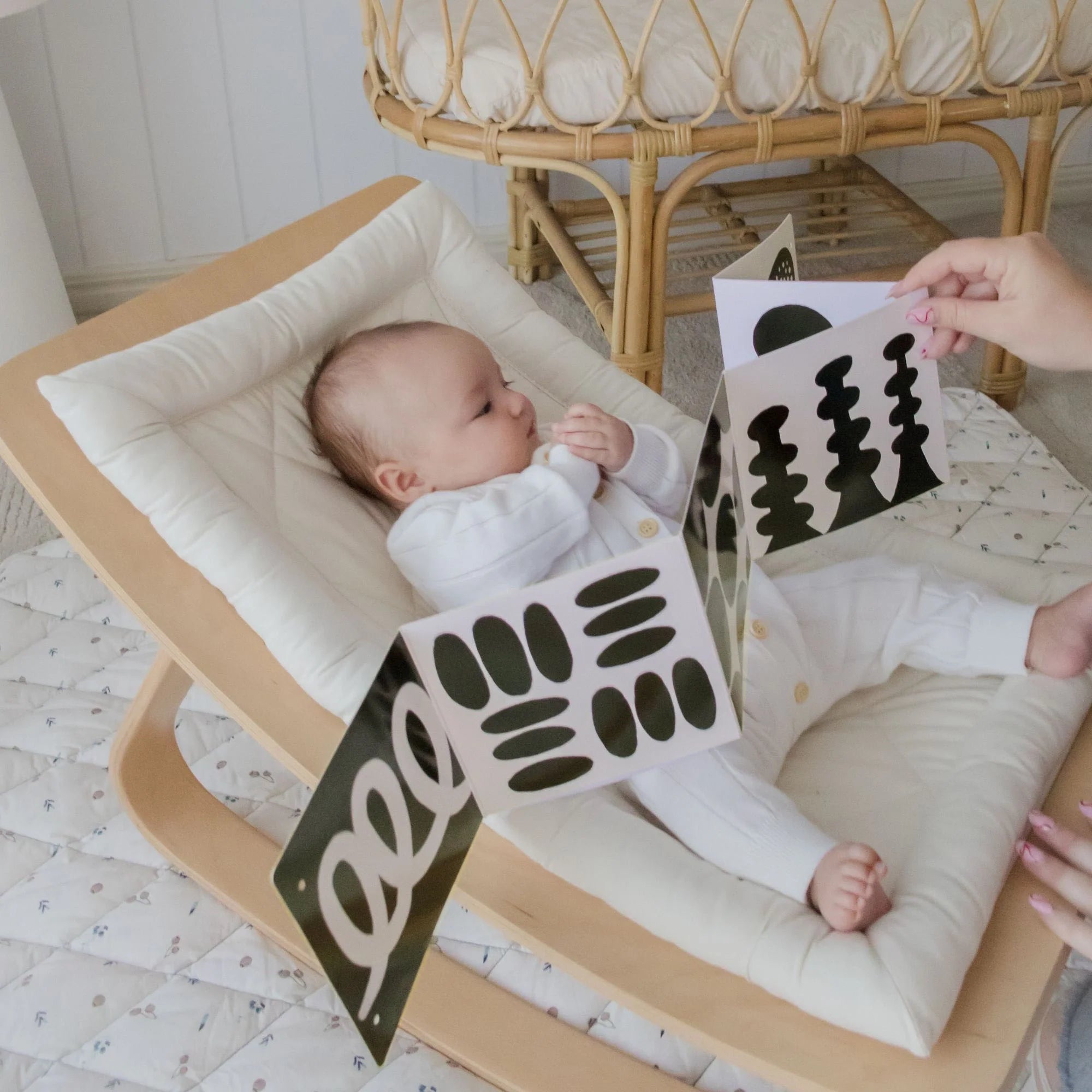 Baby in floor rocker looking at graphic cards
