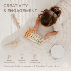 Child playing with wooden musical instruments on a textured surface, emphasizing creativity and engagement.