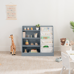 Blue kids bookshelf with open shelving and fabric compartments for books and toys in a playroom