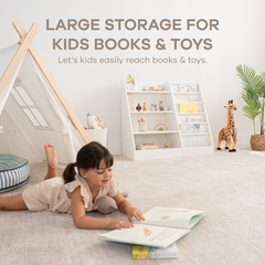 Child accessing books independently from white Montessori front-facing bookshelf in a nursery