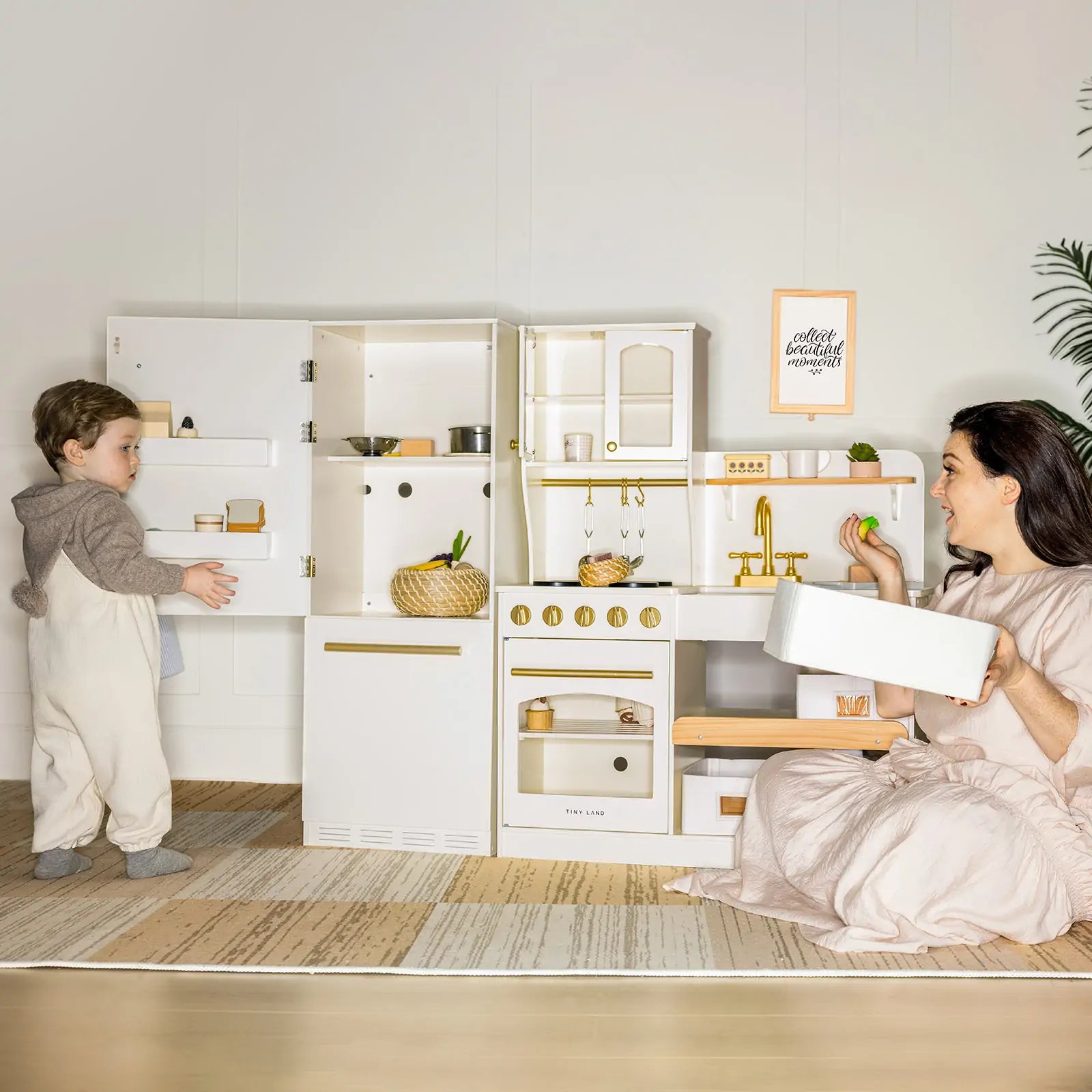 Mom and child playing with wooden kitchen set