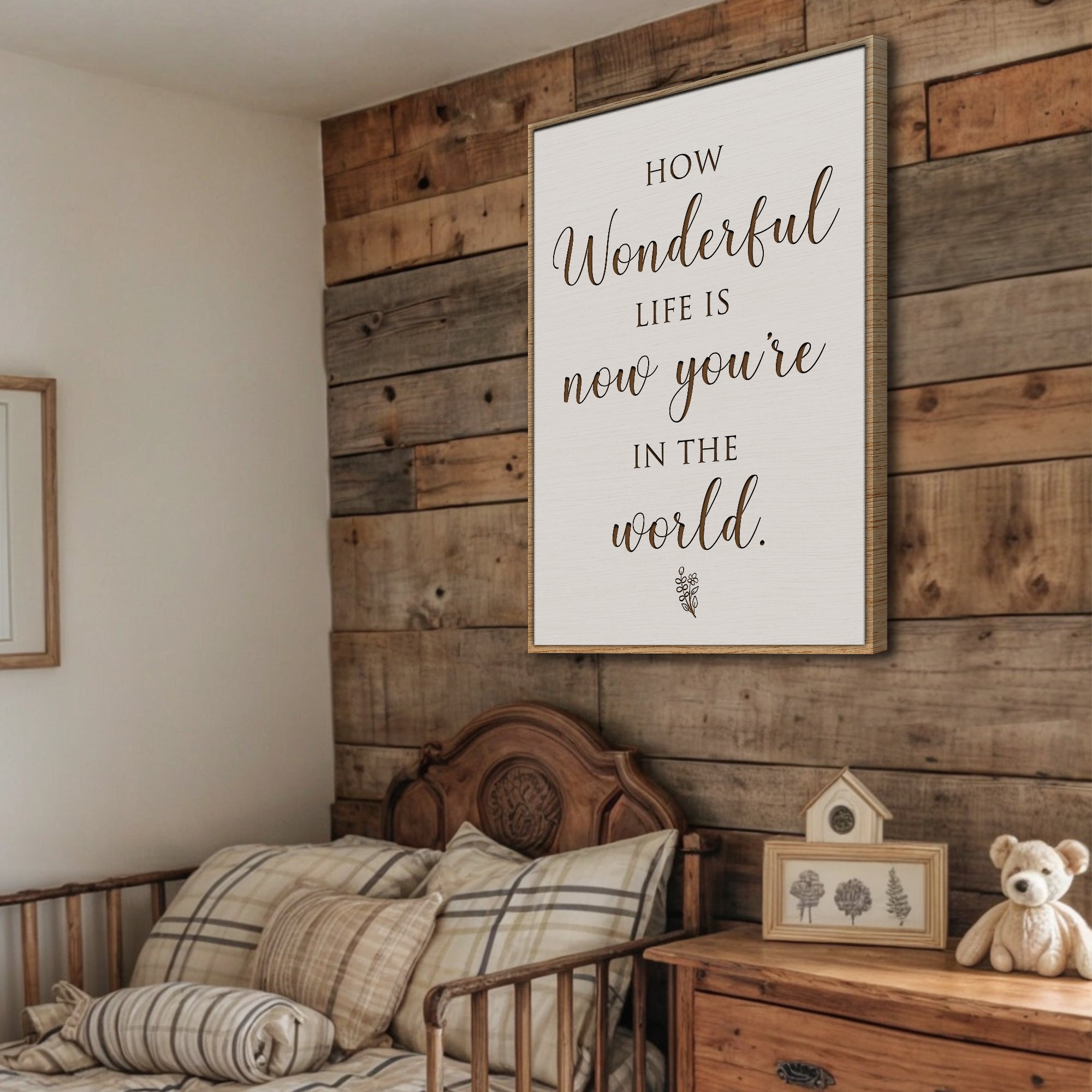 Wooden wall with framed quote, bed, and teddy bear in a cozy room.