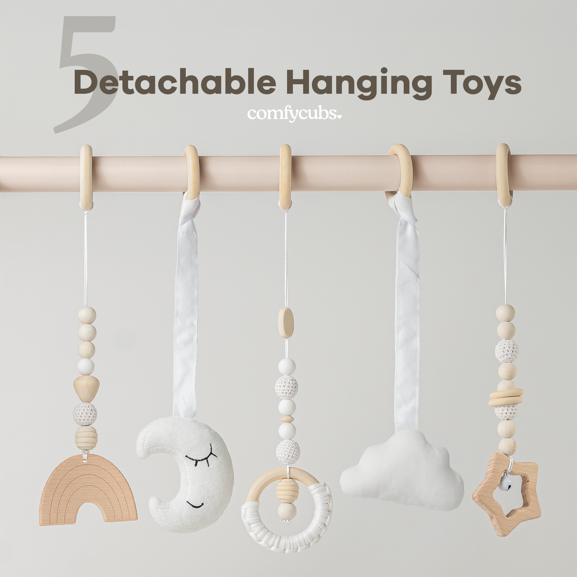 Detachable hanging toys with wooden and fabric elements on a rod against a light gray background.