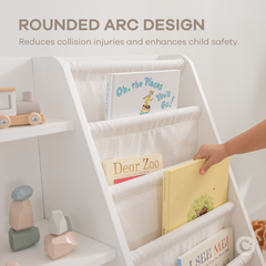 Close-up of white kids bookshelf showing fabric storage bins and wooden shelf structure