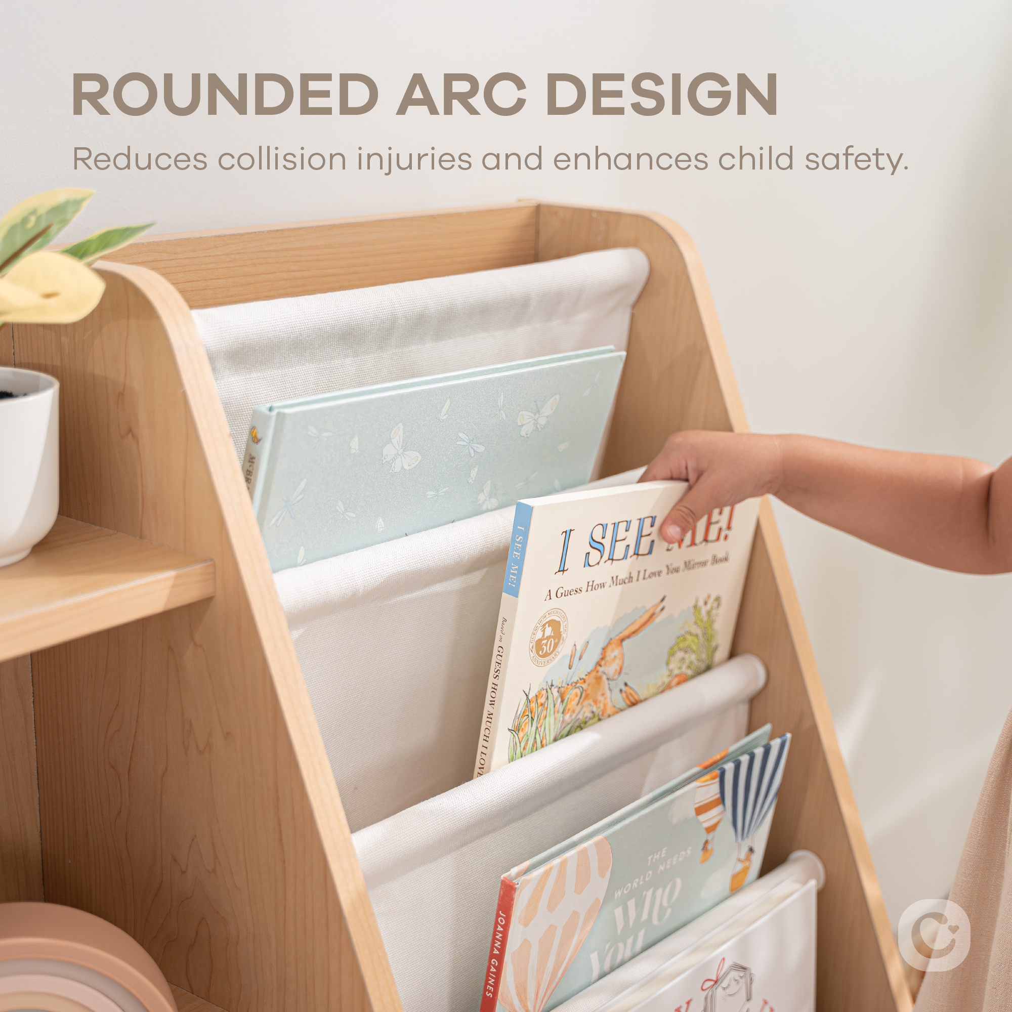 Close-up of natural wood kids bookshelf showing fabric storage bins and wooden shelf structure