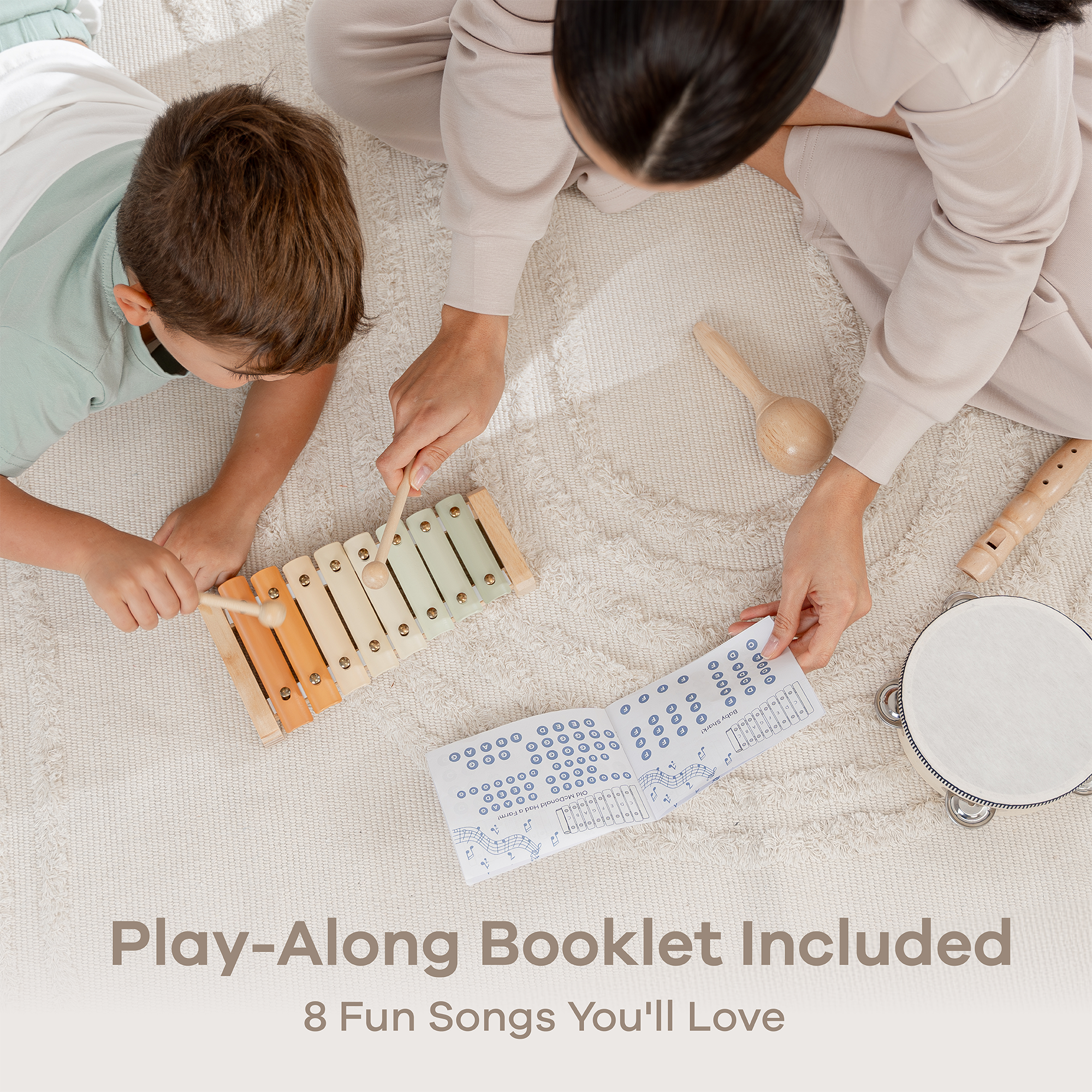 Child and adult playing with musical instruments on a light surface, with a play-along booklet included.