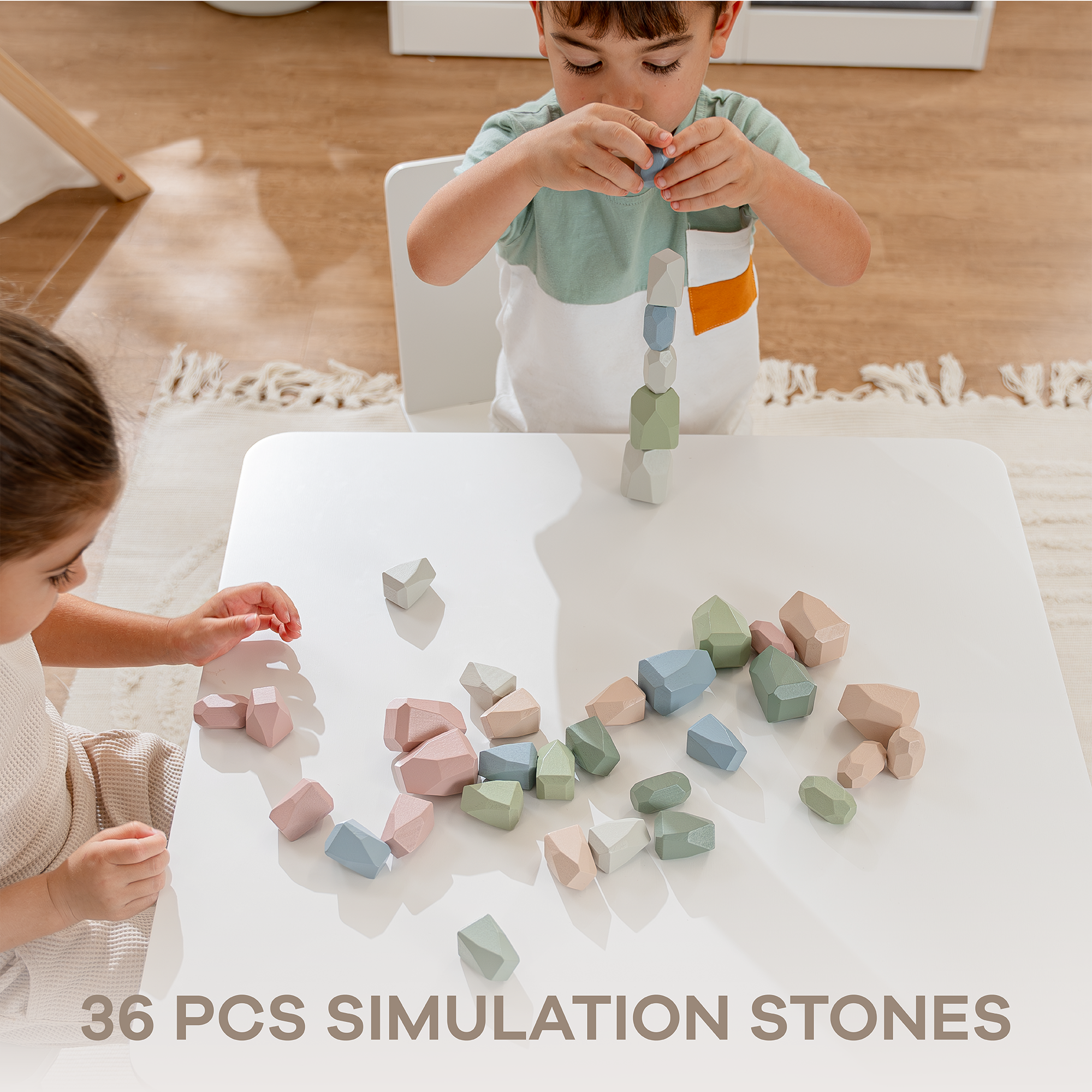 Two children playing with pastel-colored simulation stones on a white table.