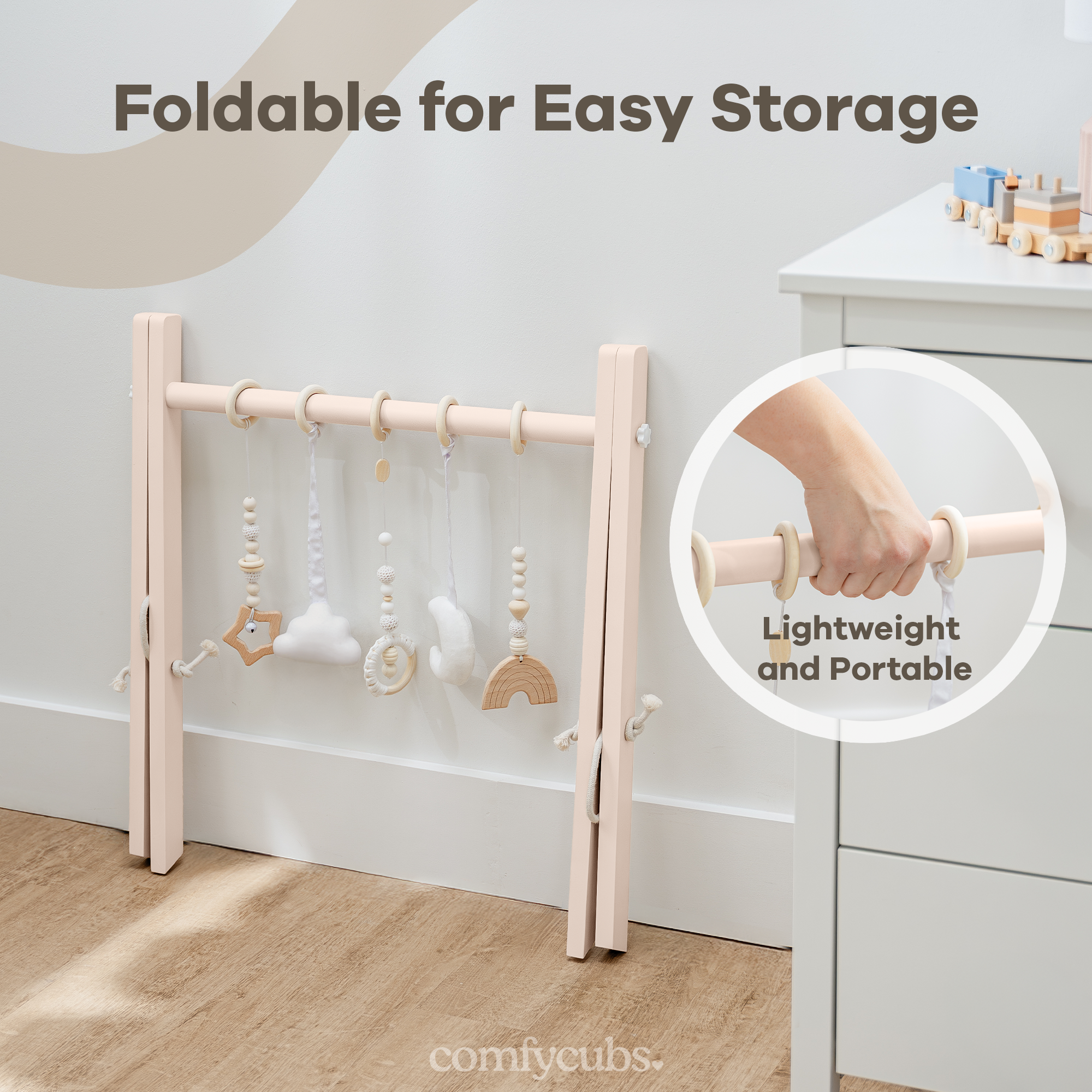 Foldable baby play gym with hanging toys, shown folded and portable, on a light wooden floor.