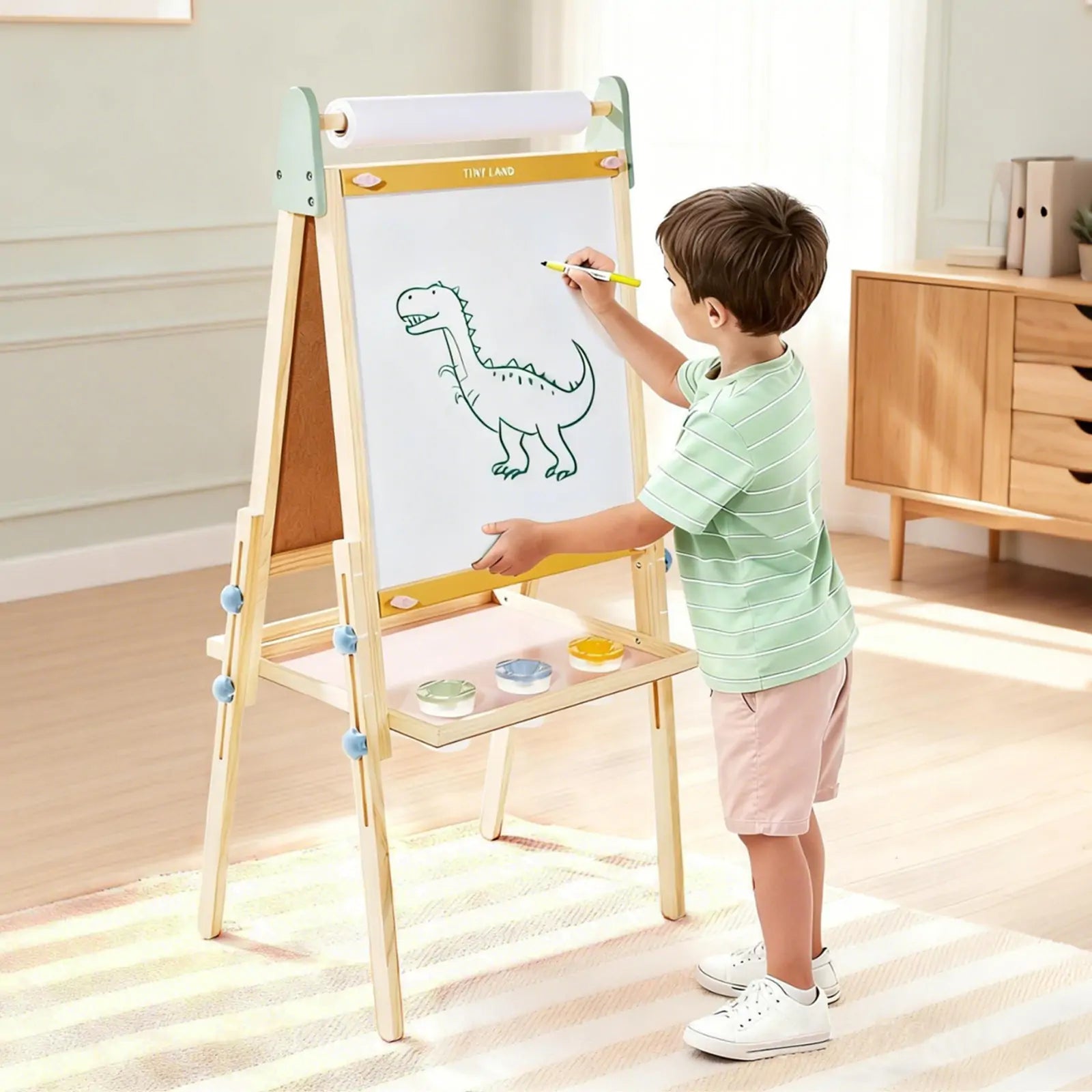Child drawing a dinosaur on the Tiny Land 3-in-1 wooden kids art easel