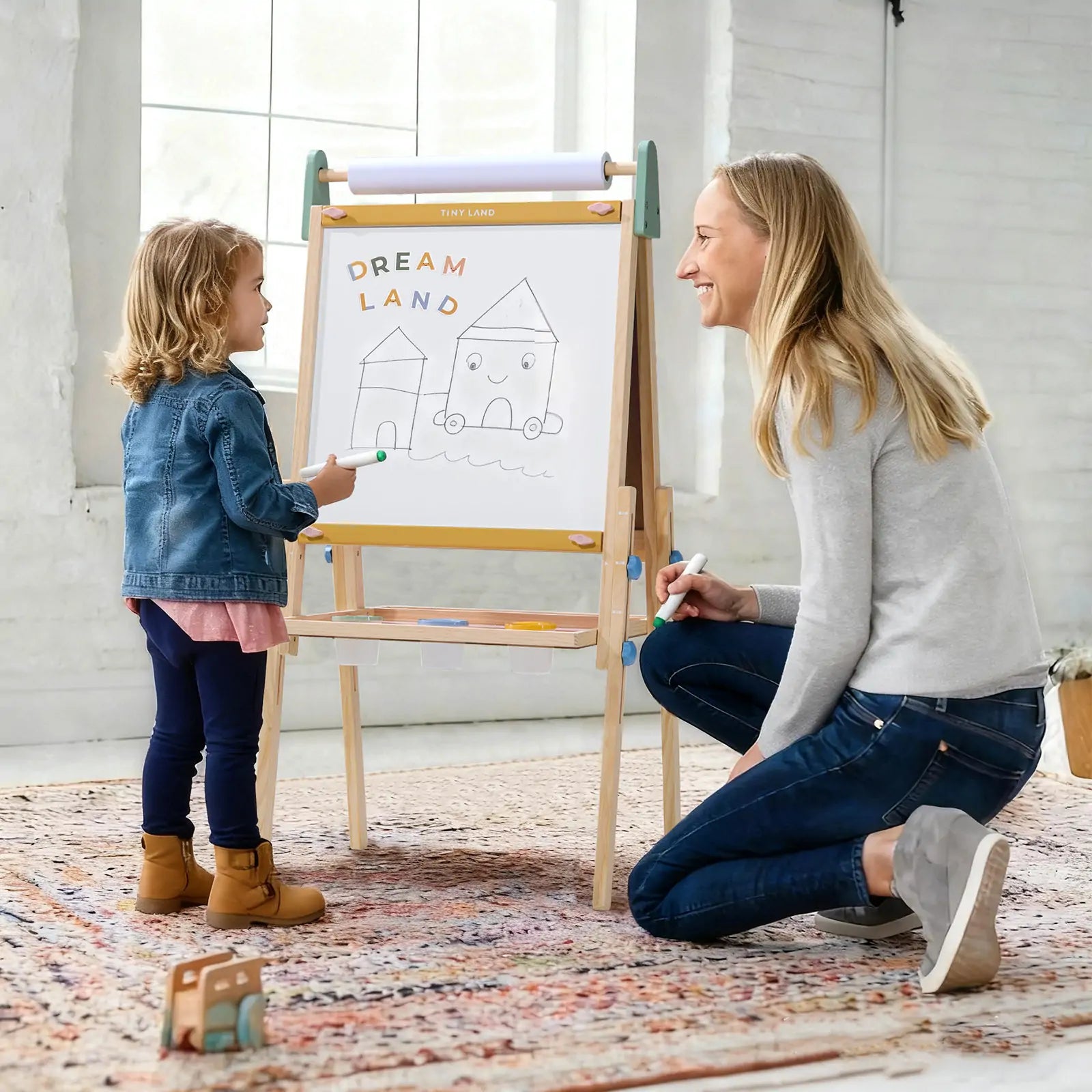 Parent and child using the Tiny Land 3-in-1 wooden kids art easel