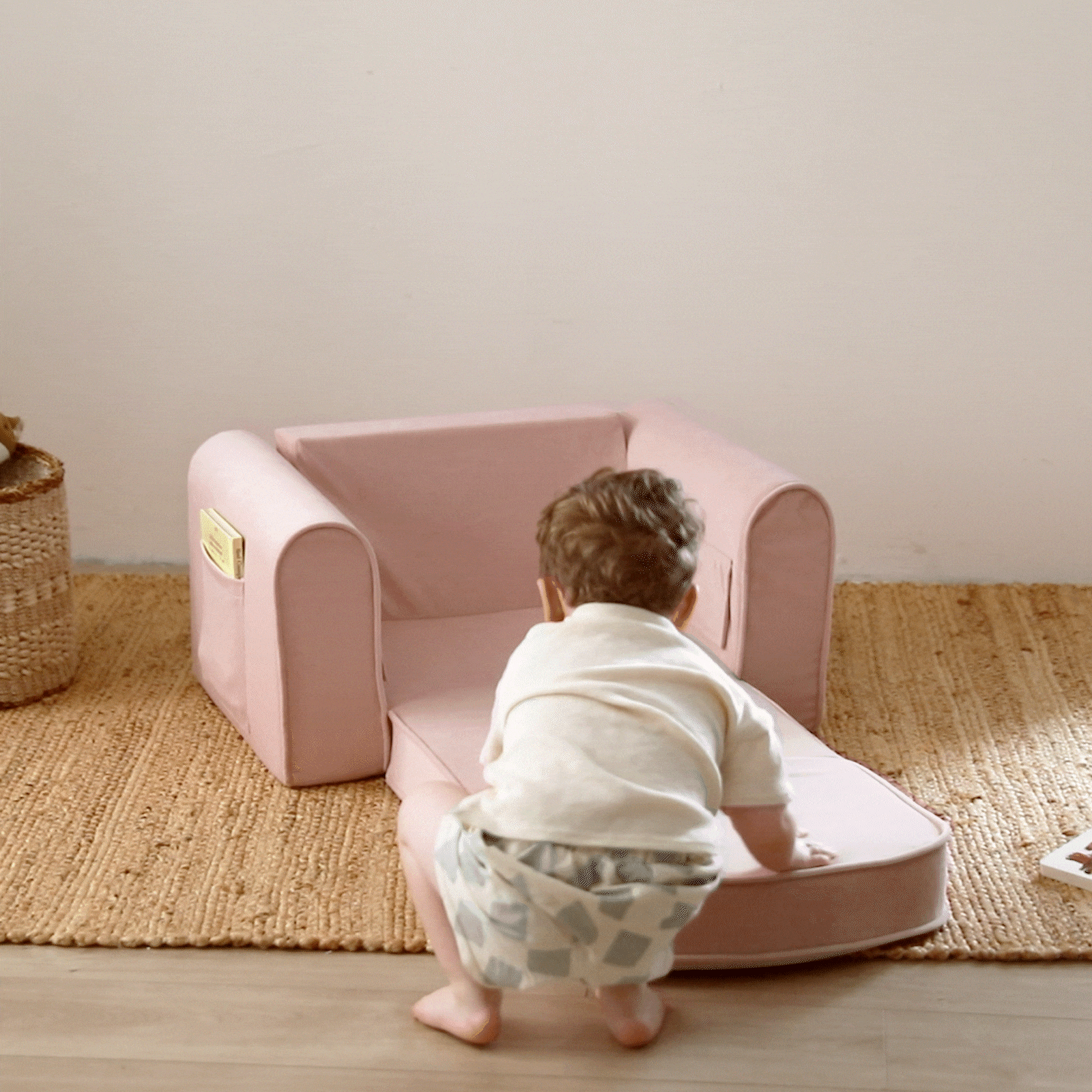 Video of child folding pink chair and then laying on it