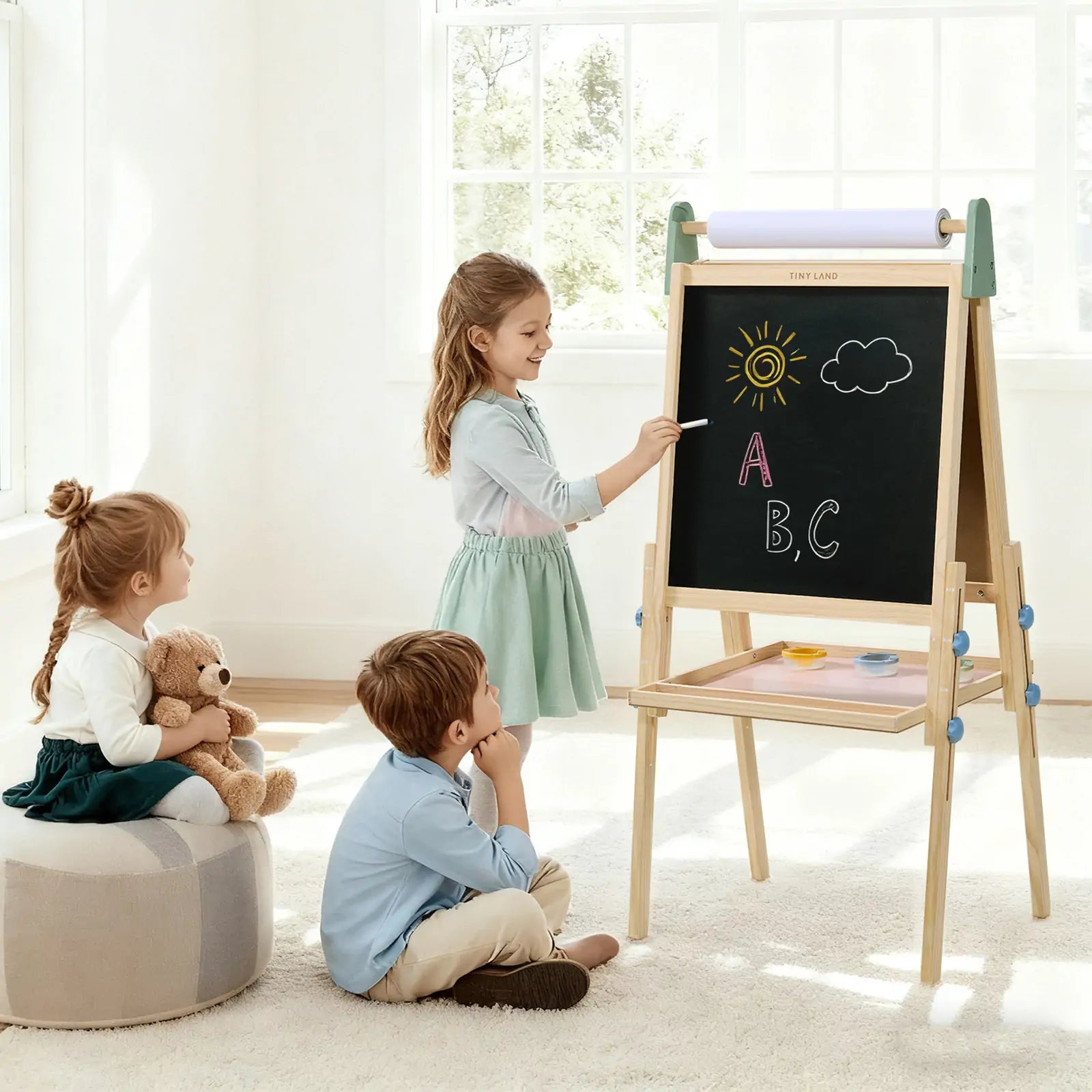Children creating art on the chalkboard side of the Tiny Land 3-in-1 wooden kids art easel