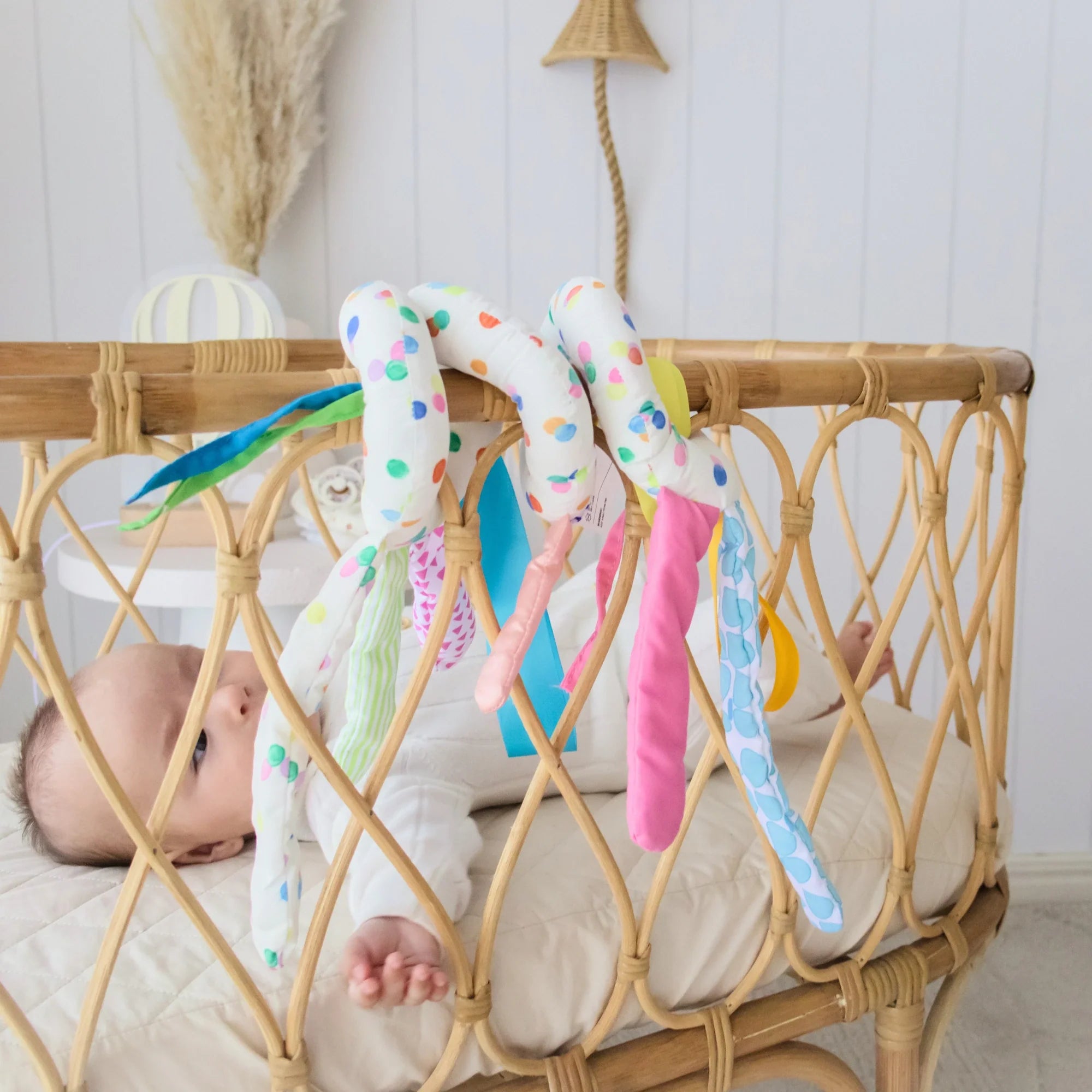 Close up image of baby in bassinet 