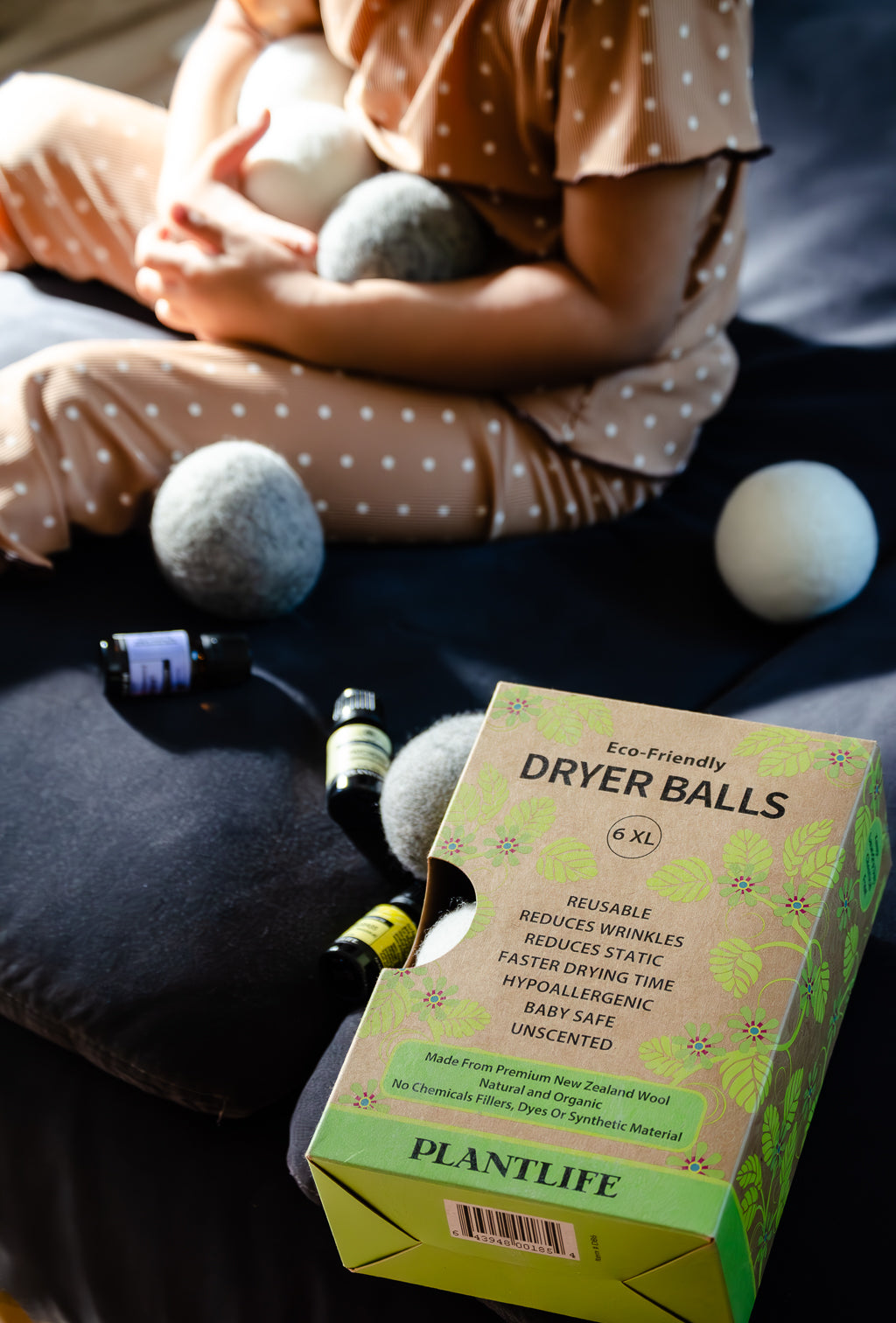 Box of Plantlife dryer balls with a person holding them in the background