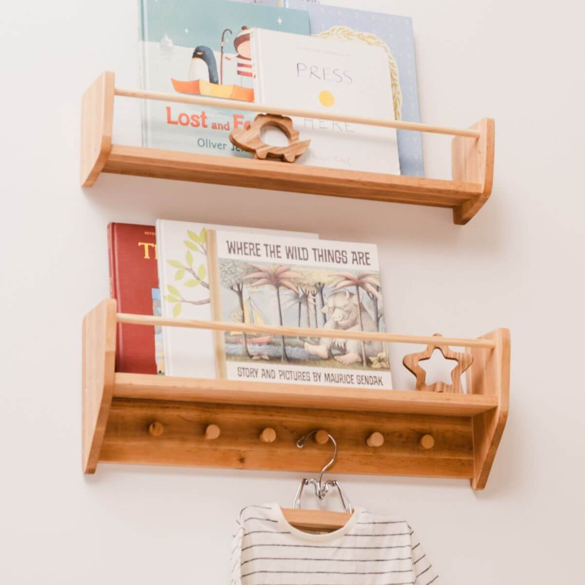 Wooden wall shelf with books and a coat hook on a white wall