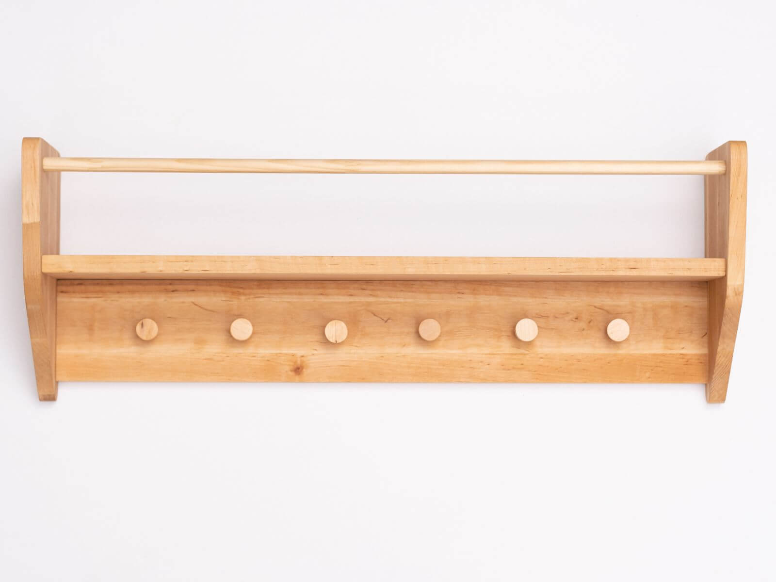 Wooden wall-mounted shelf with six hooks on a white background