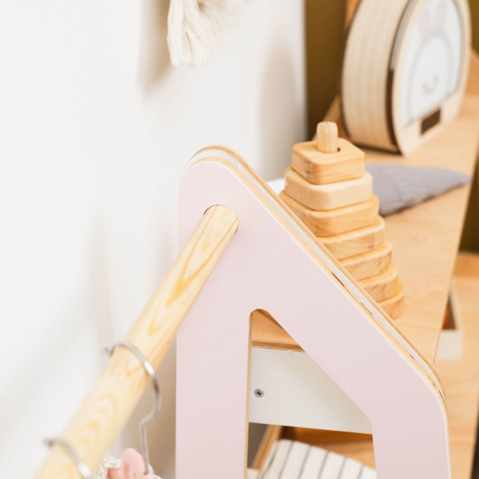 Wooden toy with a pink base on a white background