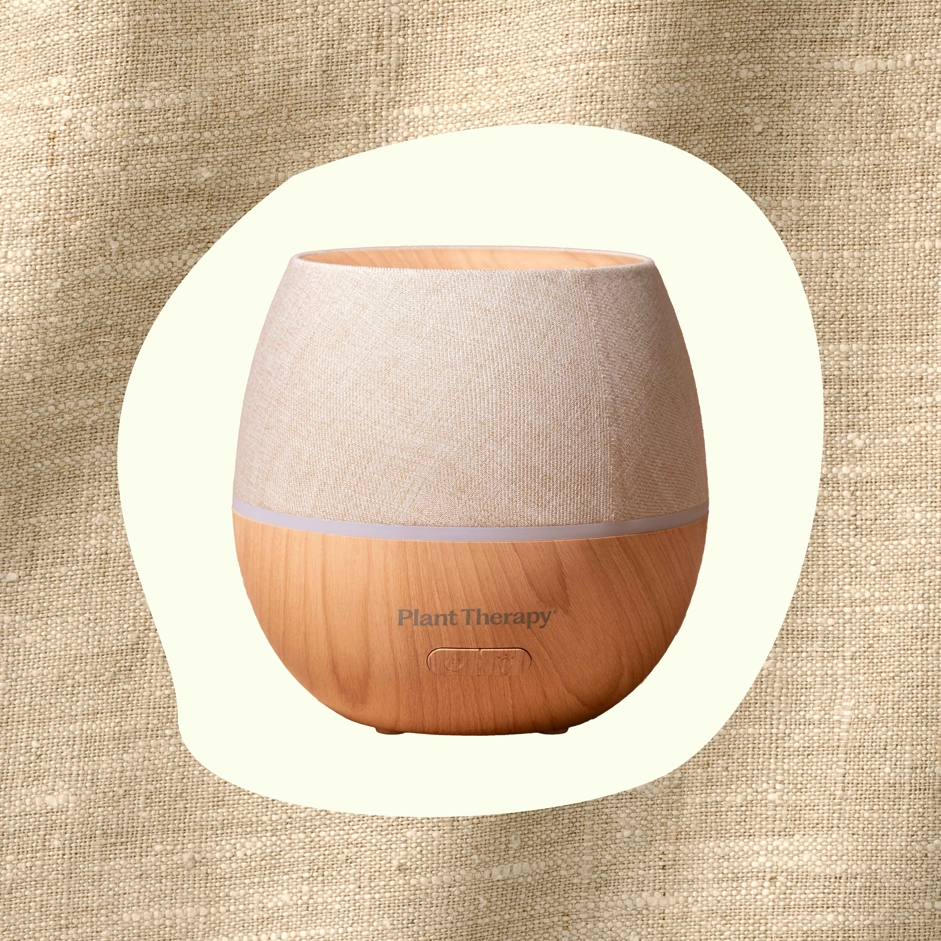 Wooden diffuser with fabric top on a beige textured background