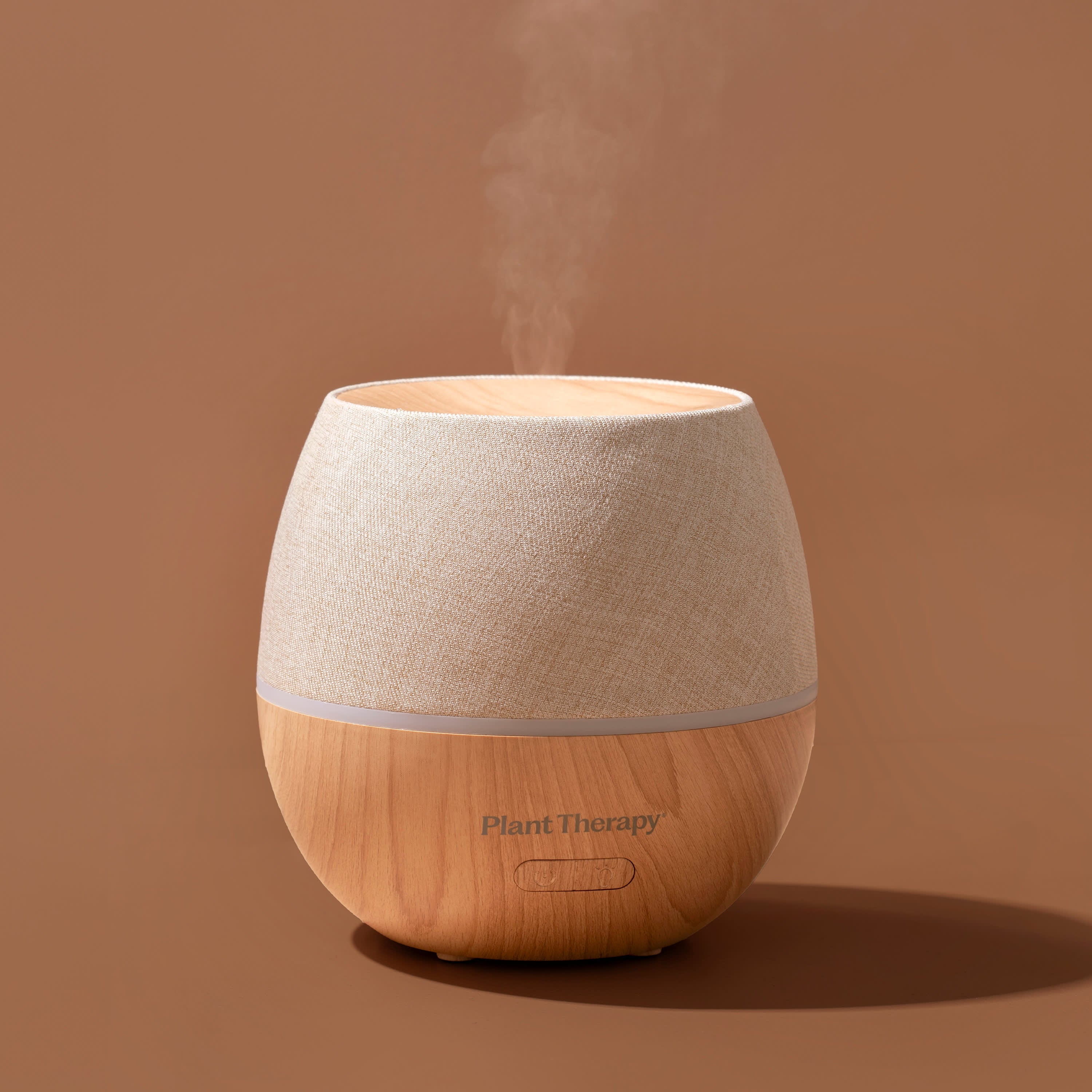 Wooden diffuser with steam on a brown background