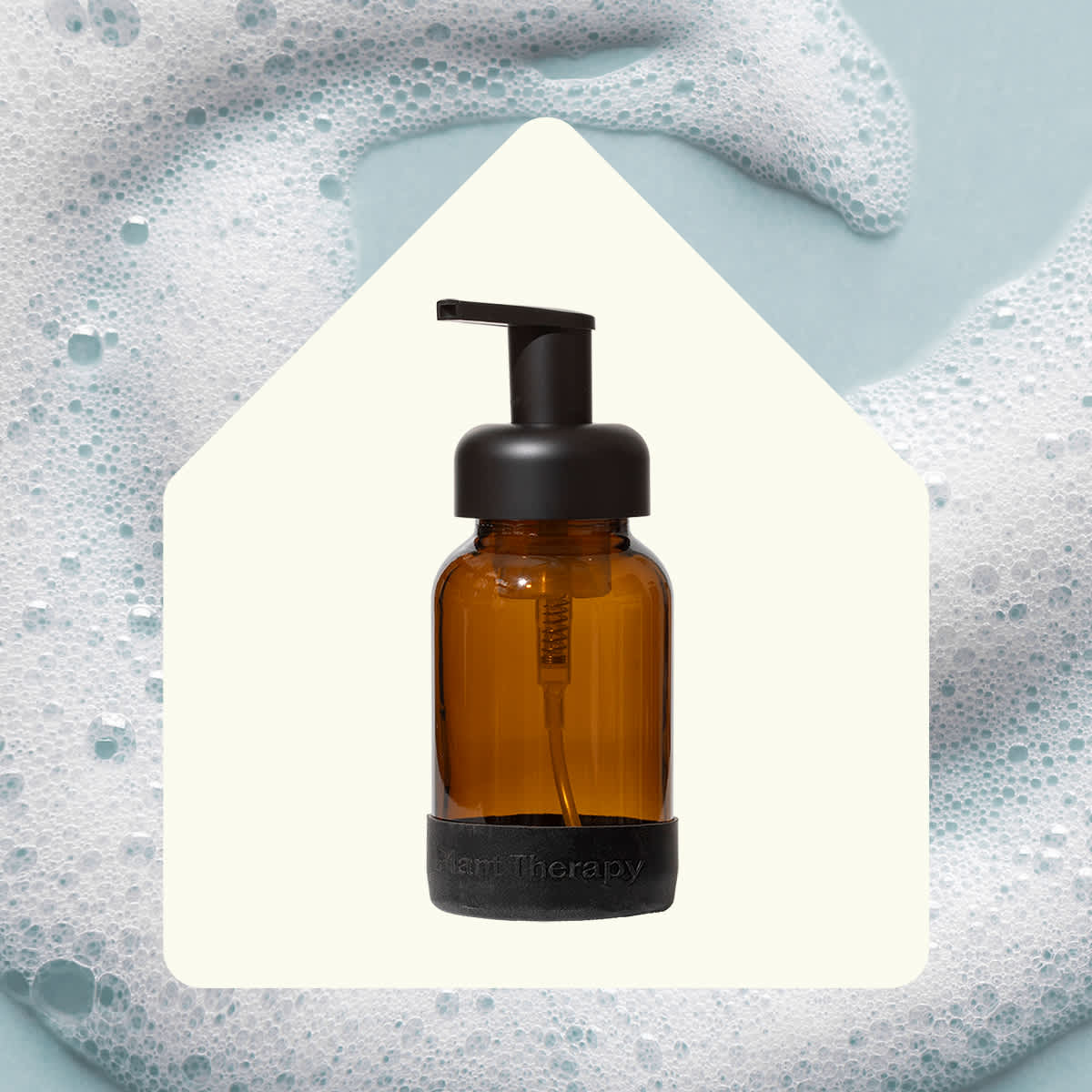 Brown bottle with black pump on a textured gray background