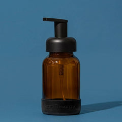 Brown bottle with black pump on a blue background