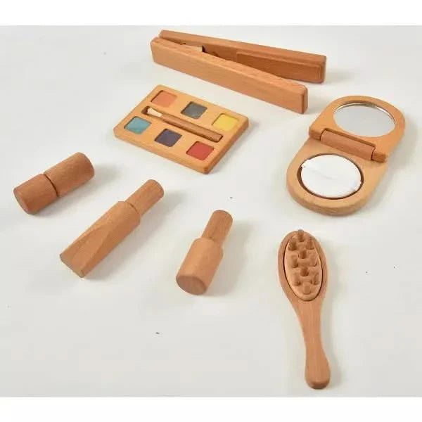Set of wooden makeup tools including a compact mirror, brush, and color palette on a white background