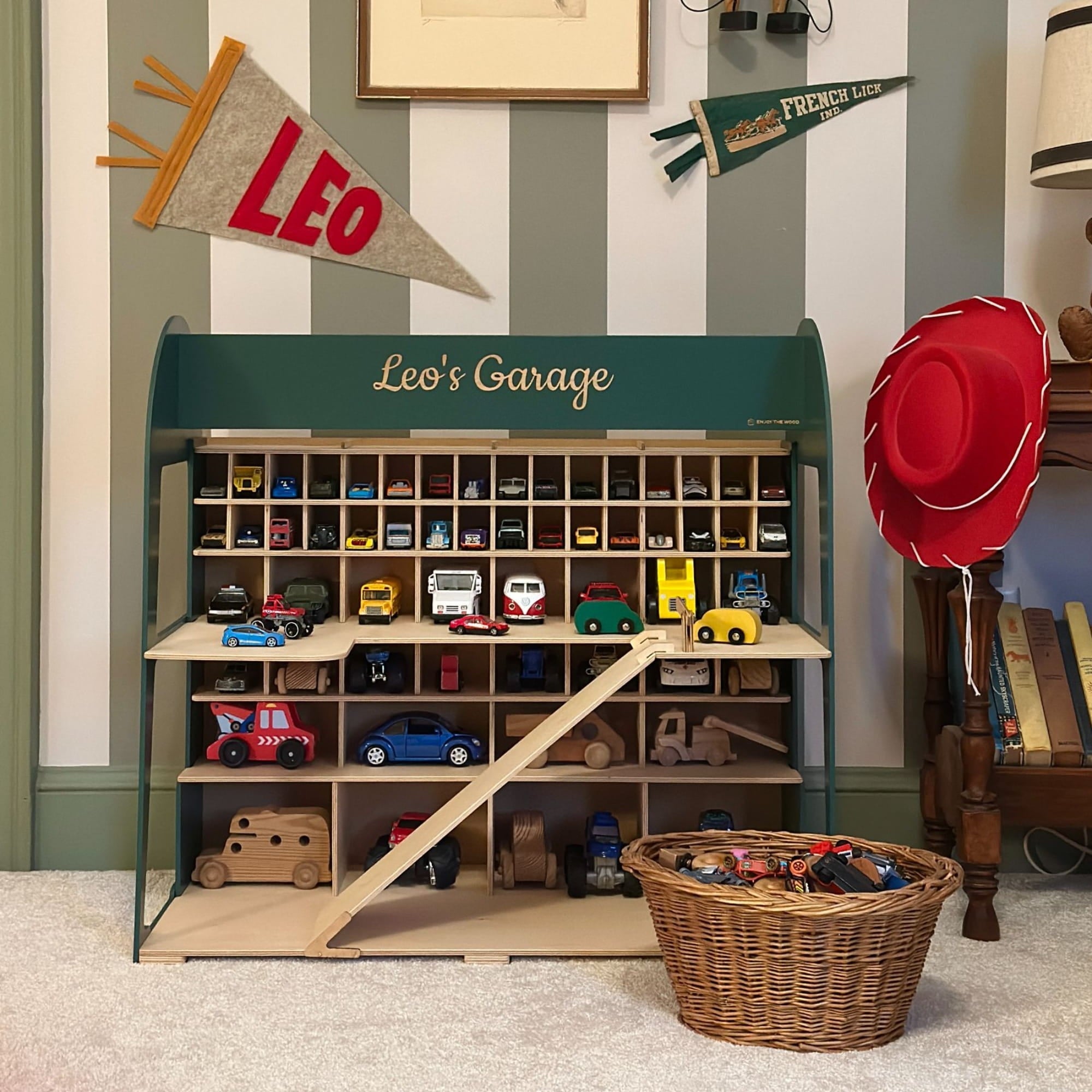 Toy garage with toy cars and a basket in a child's room