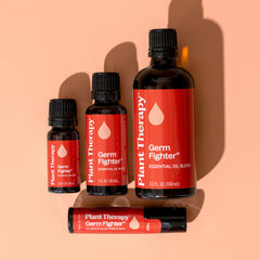 Collection of Plant Therapy Germ Fighter essential oil bottles on a peach background