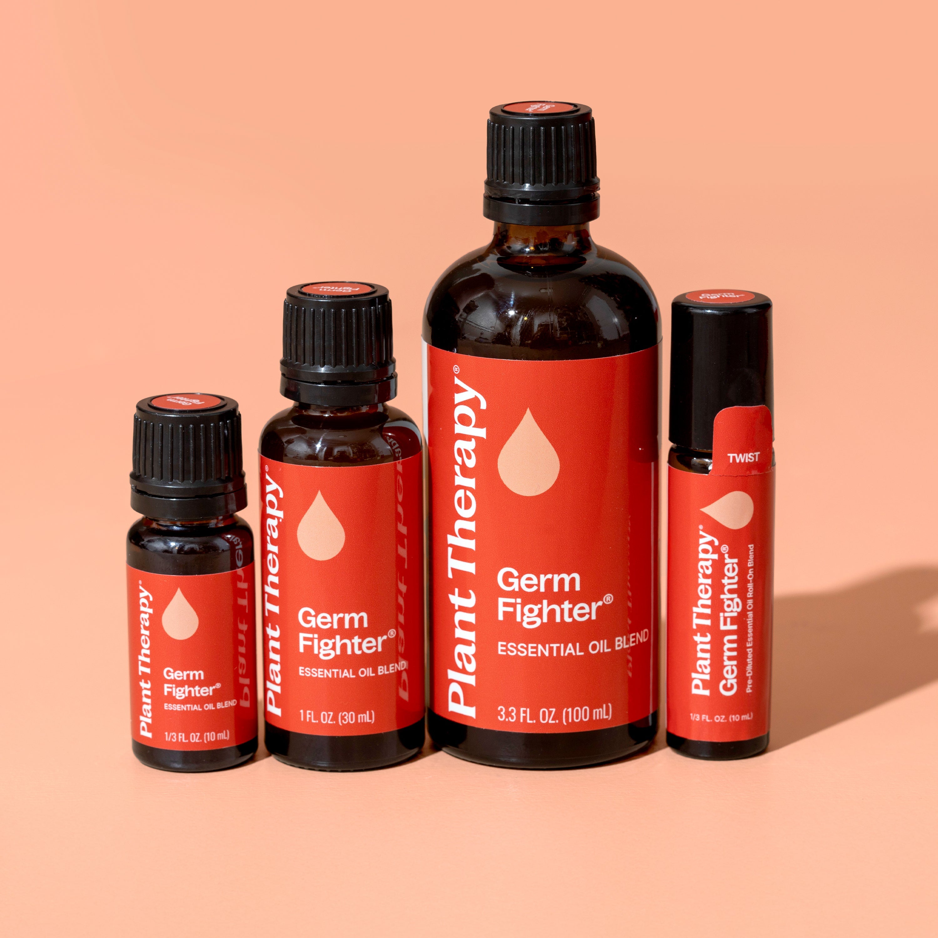 Collection of Plant Therapy Germ Fighter essential oil products on a peach background