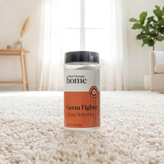 Bottle of 'Germ Fighter' carpet refresher on a carpeted floor with a home interior background.